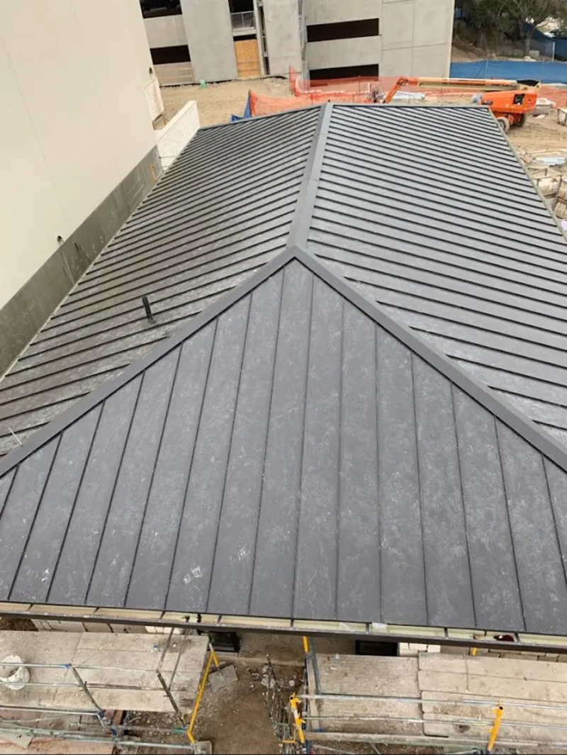 Commercial metal roof construction with crane equipment in Antrim